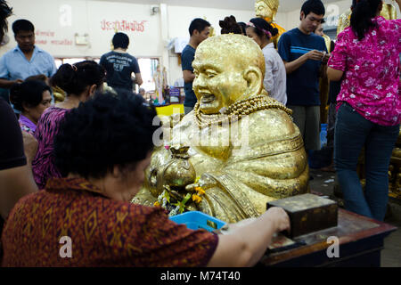 Chachoengsao, Thailandia - Agosto 7, 2010 : buddista di donare denaro e mettere la foglia di oro su buddha a tempio Sothorn Chachoendsao provincia della Thailandia Foto Stock