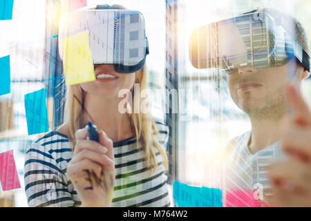 La gente in realtà virtuale bicchieri guardando alla superficie trasparente e di pensiero Foto Stock