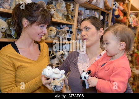 Shopping presso il negozio di giocattoli Foto Stock