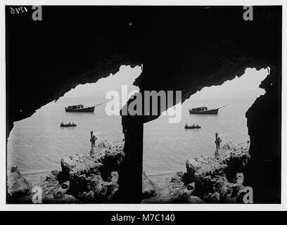 Una fotografia scattata da una grotta di Jebel Usdum, affacciata sul Mar morto. L'immagine cattura il paesaggio aspro che circonda questo lago di acqua salata, evidenziando le sue caratteristiche geografiche uniche e la bellezza naturale della regione. Foto Stock