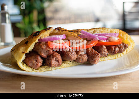 Deliziosa carne bovina serbo kebab in sandwich di pane pita con insalata fresca ingredienti Foto Stock