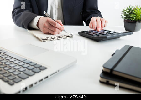 Vista ravvicinata del contabile o ispettore finanziario mani rendendo relazione, il calcolo o il controllo di equilibrio. Foto Stock