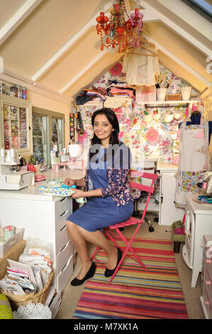 Manjit Sidhu nella foto con lei-capannone in cui ella si prende il tempo per cucire. Foto Stock