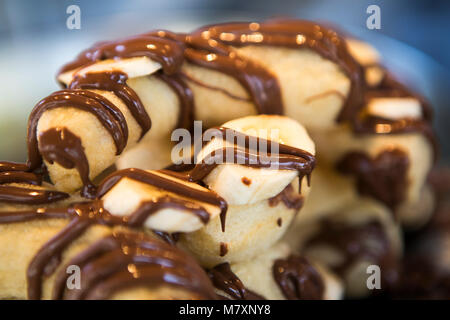 Banana e cioccolato churros. Foto Stock