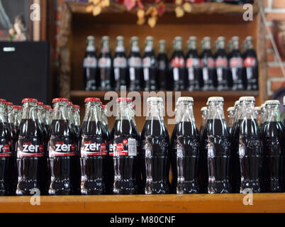 File di bottiglie di Coca Cola in primo piano e sullo sfondo Foto Stock