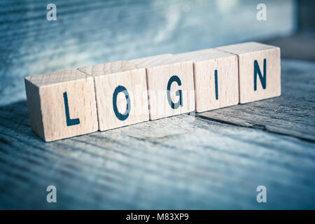 Macro di Word Login formata da blocchi di legno su un pavimento di legno Foto Stock