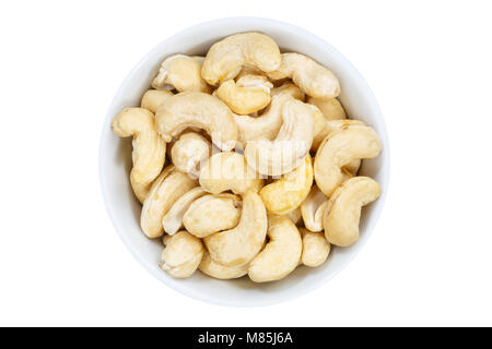 Noci di acagiù anacardi dal recipiente di cui sopra isolata su uno sfondo bianco Foto Stock