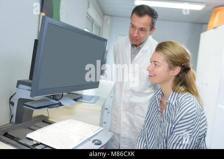 Medico spiegando la diagnosi per il suo paziente femmina Foto Stock