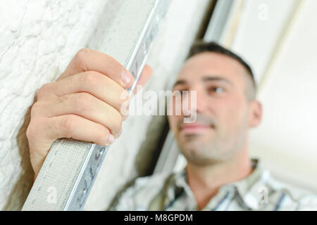 Builder holding piazza barra in metallo Foto Stock