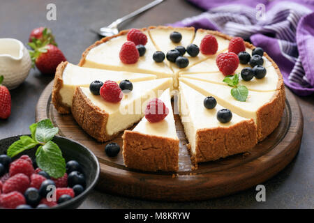 Classic plain New York cheesecake a fette sulla tavola di legno, primo piano, il fuoco selettivo Foto Stock