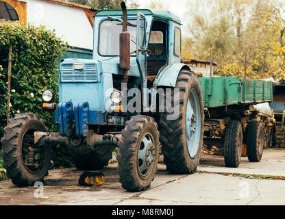 Il vecchio trattore arrugginito. Macchina agricola fatiscenti anteriore dell'azienda. Ferro vecchio. Il trattore è in attesa di essere demolito. Azienda abbandonata Foto Stock