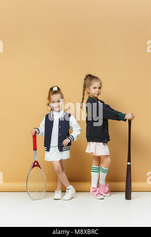 Ritratto di due ragazze come i giocatori di tennis holding racchetta da tennis. Studio shot. Foto Stock
