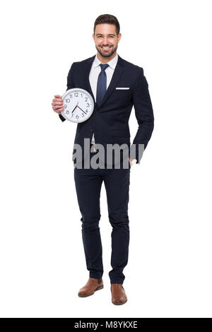 Giovane imprenditore stylishg con denti sorriso holding orologio, isolato su bianco Foto Stock