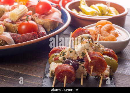 Piccoli antipasti su spiedino con formaggio, olive e salsiccia. Le tapas o antipasto Foto Stock