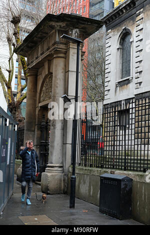 Uomo che cammina oltre la risurrezione porta, St Giles nei campi, Londra. Foto Stock