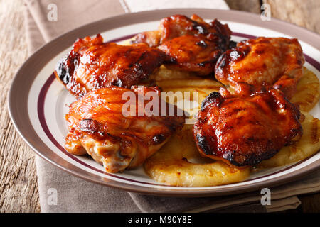 Hawaiian grill piccante di cosce di pollo huli huli con ananas closeup su una piastra orizzontale. Foto Stock