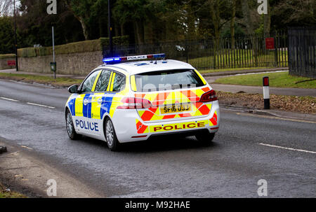 Rispondendo a una chiamata di emergenza 999, una polizia Scozia auto di polizia con luci blu lampeggiante velocità giù macalpine Road a Dundee, Scozia Foto Stock