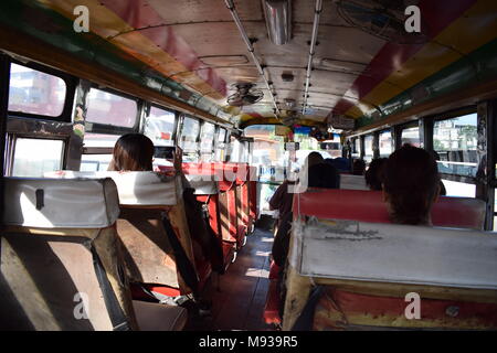 Girato dal retro di un vecchio arrugginito e strappato thailandese bus dall' ultimo sedi in Amphawa, Thailandia con ventole DIY sul tetto per AC. Foto Stock