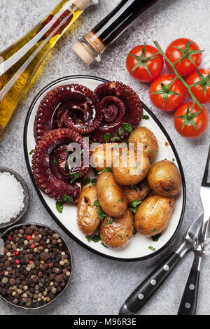 Polpo alla griglia con patate piccole con erbe e spezie. Vista superiore Foto Stock