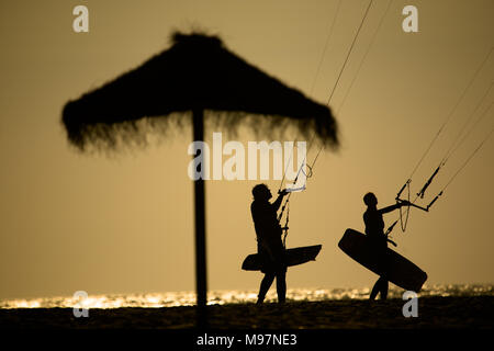 Due kite surfers ritorno alla spiaggia, Tarifa, Spagna Foto Stock