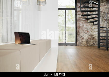 Computer portatile su un banco di lavoro in un ufficio moderno Foto Stock