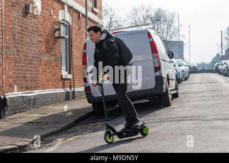 Ragazzo in scooter elettrici la guida alla scuola di inglese nel Regno Unito Foto Stock