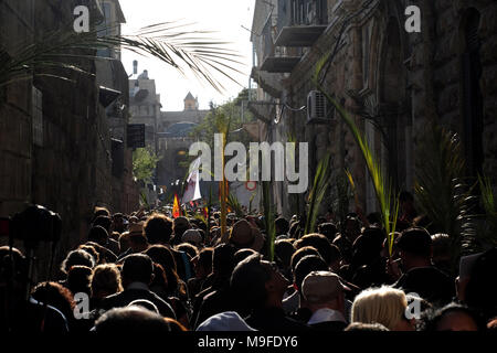 Gerusalemme, Israele 25 marzo. 2018. Gli adoratori cristiani tengono i fronti delle palme mentre prendono parte alla tradizionale processione della Domenica delle Palme lungo Via dolorosa nella Città Vecchia di Gerusalemme, il giorno che segna per i cristiani l'ingresso di Gesù Cristo a Gerusalemme, quando i suoi seguaci posero i rami delle palme nel suo cammino, Prima della sua crocifissione e segna l'inizio della settimana Santa, che termina a Pasqua. Foto Stock