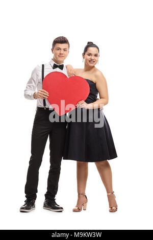 A piena lunghezza Ritratto di un vestito elegantemente teenage giovane con un cuore isolato su sfondo bianco Foto Stock