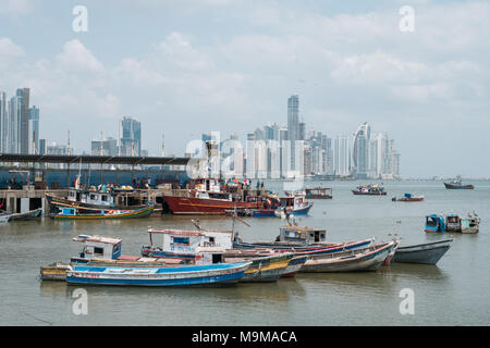 Panama City, Panama - marzo 2018: i pescatori e barche sul mercato del pesce / Harbour con lo skyline della citta', Panama City. Foto Stock