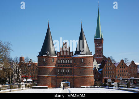 Holstentor in inverno nella neve, Salzspeicher e chiesa di San Petri, Lubecca, Schleswig-Holstein, Germania Foto Stock