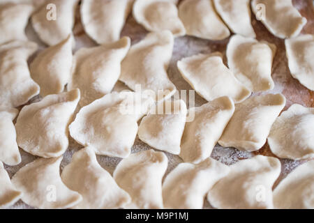 Raw gnocchi fatti in casa su sfondo di legno vicino. Foto Stock