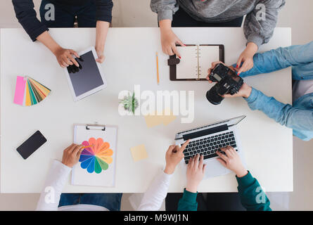 Giovane team creativo avente una riunione in ufficio creativa - il lavoro di squadra concetti. Foto Stock