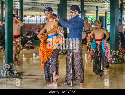 Maestro di danza correggendo la postura di una giovane ballerino durante Beksan Putra e tradizionale palazzo maschio performance di danza presso il Kraton Ngayogyakarta H Foto Stock