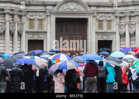 Londra, Regno Unito. Il 30 marzo 2018. Adoratori shleter sotto gli ombrelloni fuori Cattedrale di Westminster in un umido Venerdì Santo Credito: amer ghazzal/Alamy Live News Foto Stock