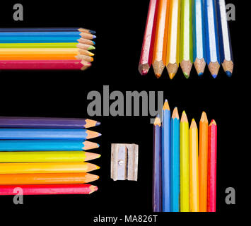 Sette colorato disegno penne e sharpener isolato sul nero, affinare le tue abilità, espressione creativa rainbow concept Foto Stock