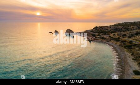 Antenna ad occhio d'uccello del Petra tou Romiou, aka roccia di Afrodite una famosa località turistica meta di viaggio landmark in Paphos, Cipro. Il mare della baia di dea Foto Stock