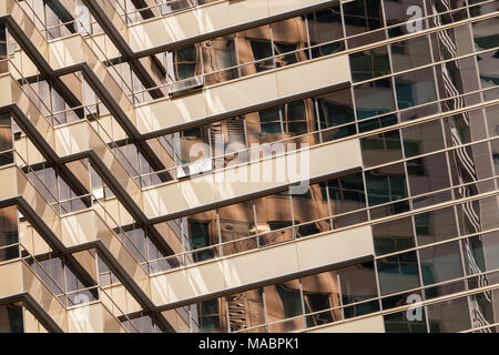 Frammento astratto di architettura contemporanea, pareti in oro tonica vetro con riflessioni Foto Stock