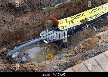 Grande il cavo elettrico al connettore danneggiato riparazione cavo principale in strada. Foto Stock