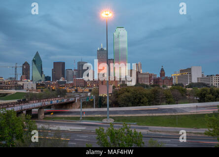 Il centro cittadino di Dallas Skyline che riflette i colori arancione al tramonto Foto Stock