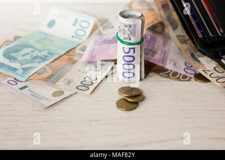 Varie il serbo carta moneta banconote e portafoglio sul tavolo di legno, close up shot Foto Stock