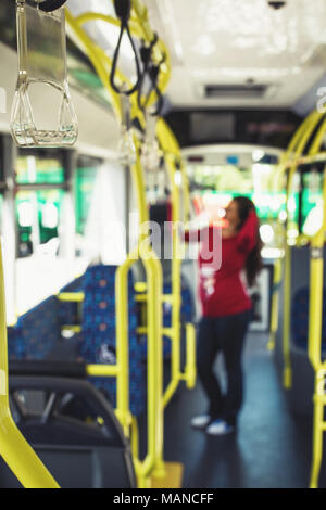 Silhouette di una giovane donna incinta in viaggio con i mezzi di trasporto pubblico verso il lavoro/ scuola Foto Stock