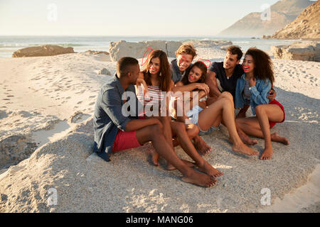 Gruppo di amici in relax sulla spiaggia di vacanze insieme Foto Stock