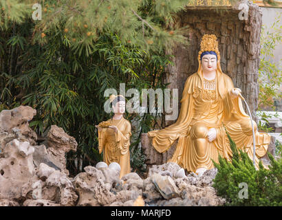 Hacienda Heights, CA, Stati Uniti d'America - 23 Marzo 2018: primo piano della golden Avalokitesvara, Guanyin, in giardino con quattro re celeste a Hsi Lai tempio buddista. Foto Stock