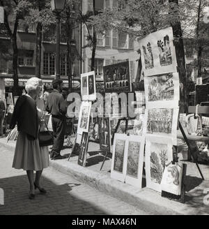 Degli anni Cinquanta, foto storiche che mostra dipinti e opere d'arte in vendita su Place du Tertre", una famosa piazza a Montmartre, Paris, Francia. La zona è ben nota per i suoi artisti di strada e ci sono molti importanti che hanno vissuto e lavorato in passato, comprese Renoir e Picasso, Foto Stock