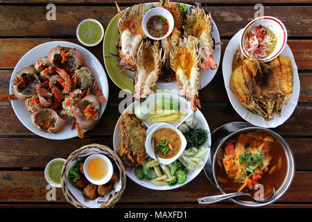 Molti tipi di frutti di mare e cibo tailandese sul tavolo di legno per la cena Foto Stock