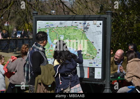Una coppia di turisti alla ricerca di una mappa di Hyde Park, Londra Foto Stock