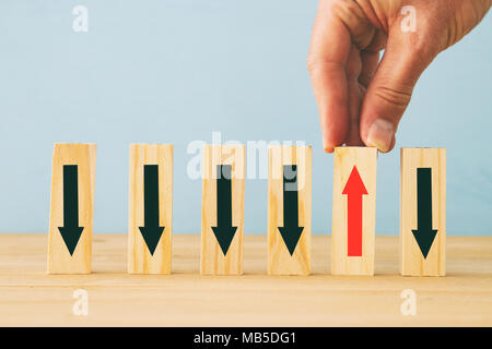 Immagine di man mano sceglierne uno da molti blocchi di legno. Concetto aziendale di scegliere il diritto fra le altre quelle, pianificazione, rischio e strategia Foto Stock