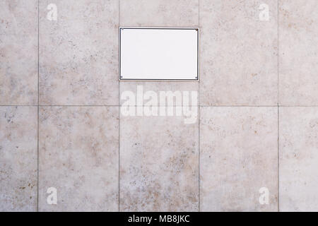 Segno bianco sulla pietra di marmo sullo sfondo della parete Foto Stock