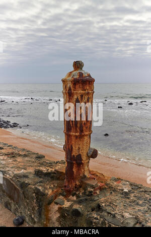 Una chiusura di uno dei più antichi canoni portoghese incorporato nella parete del mare in una posizione verticale all'Sao Sebastiao Fort su Sao Tome. Foto Stock