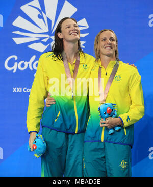 Australia Bronte Campbell celebra vincendo oro con Australia Cate Campbell che ha vinto l'argento in donne 100m Freestyle Finale al Gold Coast centro acquatico durante il giorno cinque del 2018 Giochi del Commonwealth in Gold Coast, Australia. Stampa foto di associazione. Picture Data: lunedì 9 aprile 2018. Vedere PA storia COMMONWEALTH nuoto. Foto di credito dovrebbe leggere: Mike Egerton/filo PA. Restrizioni: solo uso editoriale. Uso non commerciale. Nessun video emulazione. Foto Stock